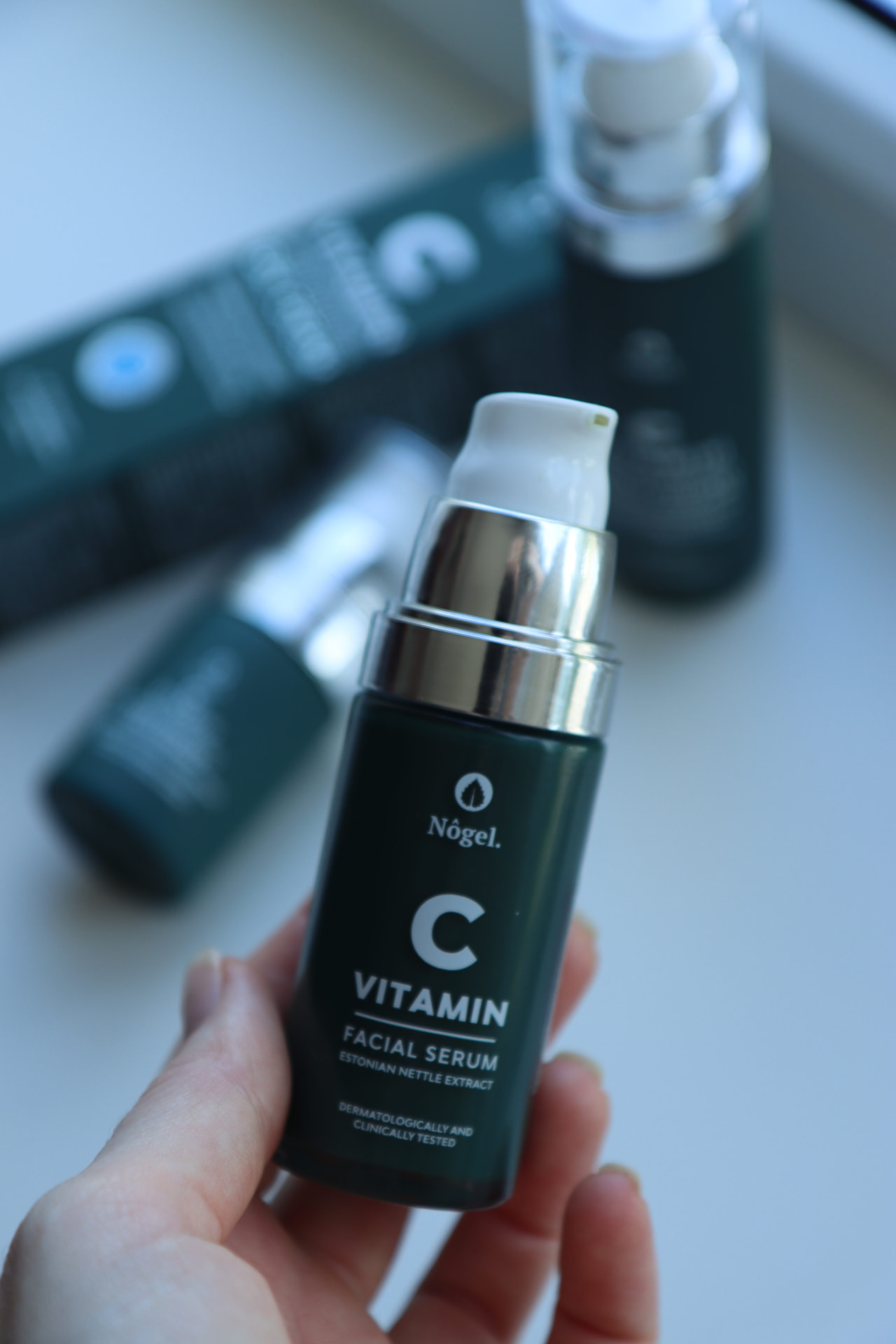 Nogel Organics vitamin C facial serum held in hand
